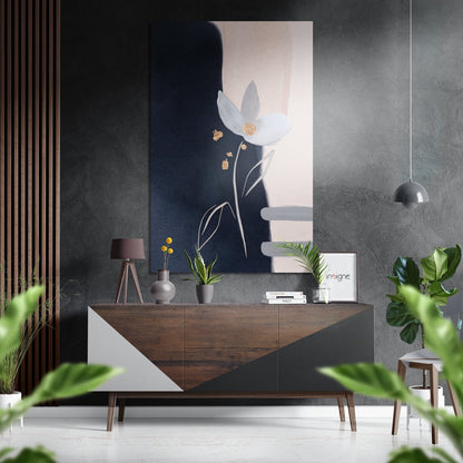 Brushed aluminium Dibond wall art displaying minimalist white flower with gold accents on dark blue background, mounted above wooden dresser in modern interior setting.