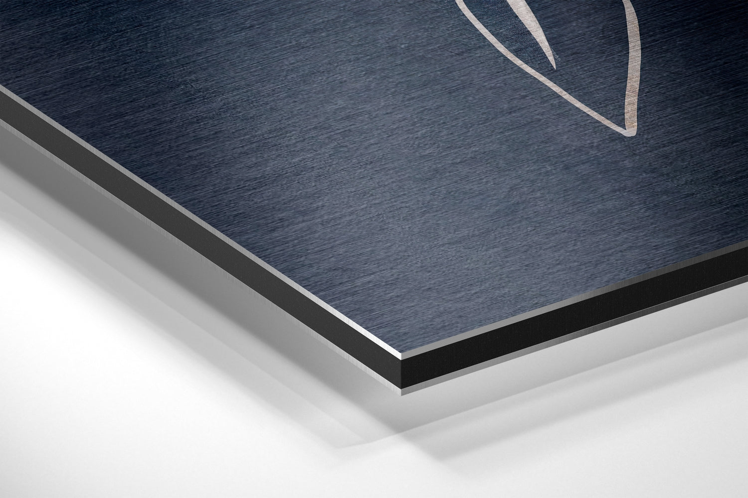 Close-up angled view of brushed aluminum dibond panel showing dark blue textured surface with black and gray layered edges.
