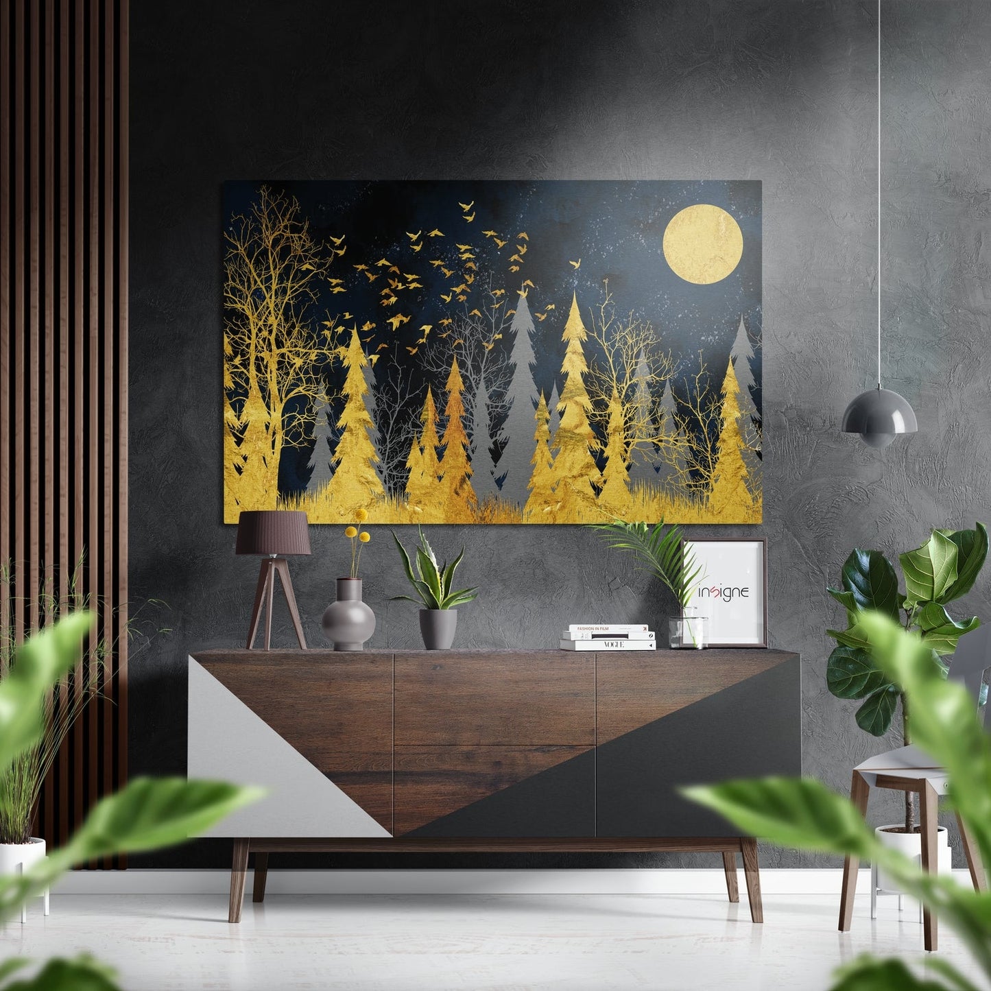 Golden forest wall art with moon and birds displayed above wooden dresser in modern interior setting.