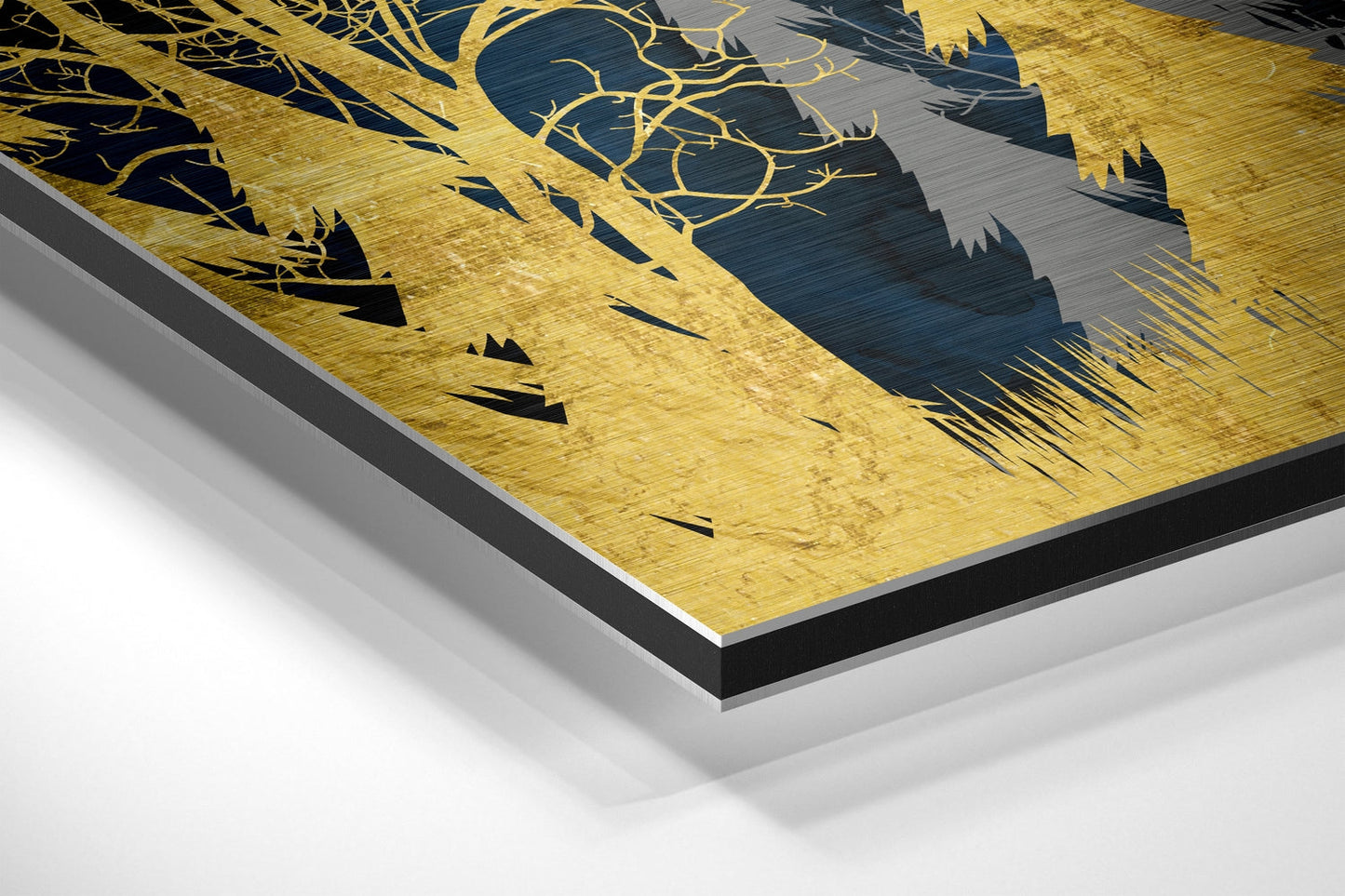 Angled perspective view of brushed gold aluminum Dibond wall art featuring black silhouettes of forest trees and branches.