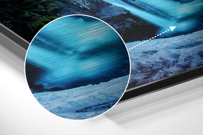 Close-up detail of brushed aluminium Dibond wall art showing blue water texture with magnified circular view and directional arrow.