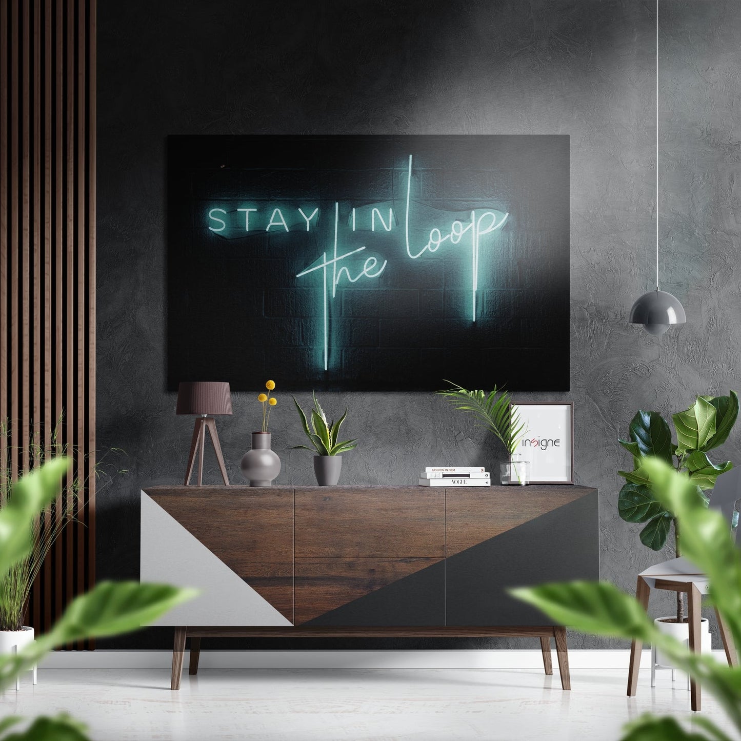 Modern living room with neon "Stay in the Loop" sign displayed above wooden credenza with potted plants and pendant lighting.