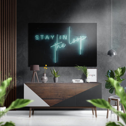 Modern living room with neon "Stay in the Loop" sign displayed above wooden credenza with potted plants and pendant lighting.