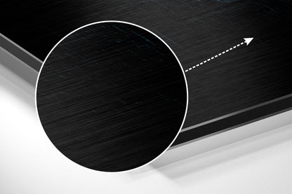 Modern abstract wall art featuring a large white-outlined black circle on brushed aluminum with directional arrow detail.