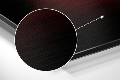Brushed dark red and black circular wall art with white border and directional arrow on angled gray and white surface.