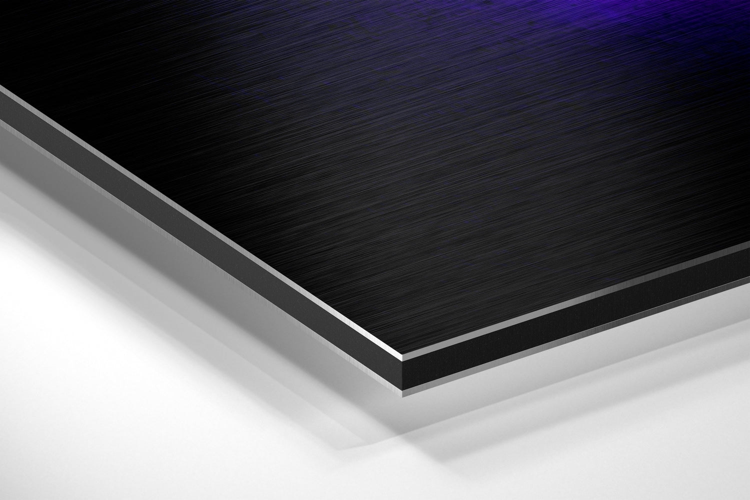 Close-up angled view of layered brushed aluminium and white core material showing edge detail and metallic surface finish.