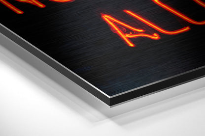 Angled perspective view of brushed aluminum Dibond panel with neon red and yellow "No Drugs" text glowing against dark textured surface.