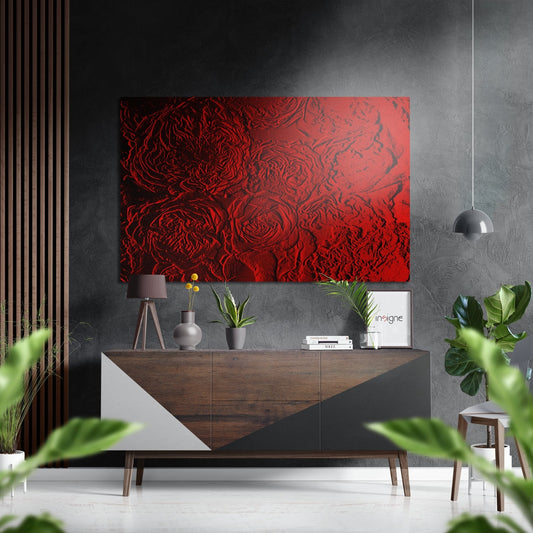 Red embossed rose pattern metal wall art displayed above a wooden credenza in a modern grey interior with pendant light and potted plants.