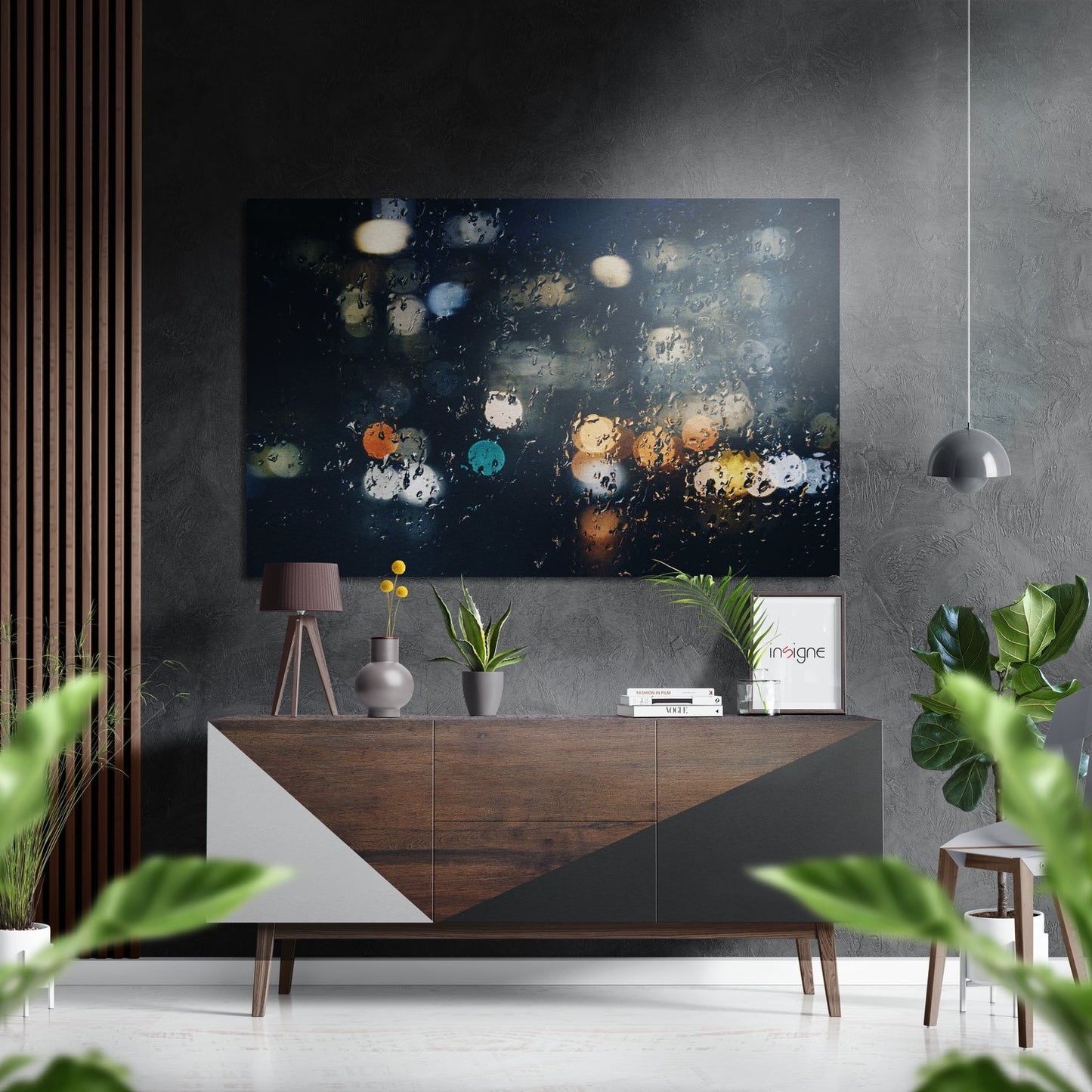Modern interior styled with dark abstract artwork featuring colorful bokeh lights displayed above a wooden sideboard with decor.