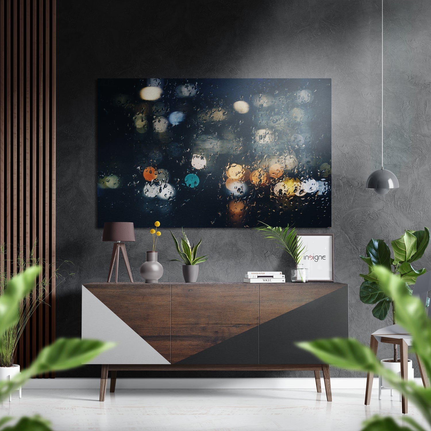 Modern interior styled with dark abstract artwork featuring colorful bokeh lights displayed above a wooden sideboard with decor.