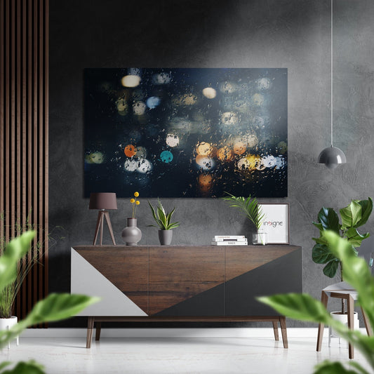 Modern interior styled with dark abstract artwork featuring colorful bokeh lights displayed above a wooden sideboard with decor.