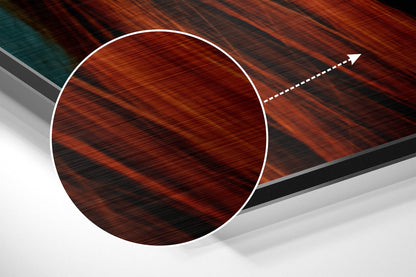Angled view of circular brushed red-brown aluminum wall art with white border and directional arrow graphic on layered geometric background.