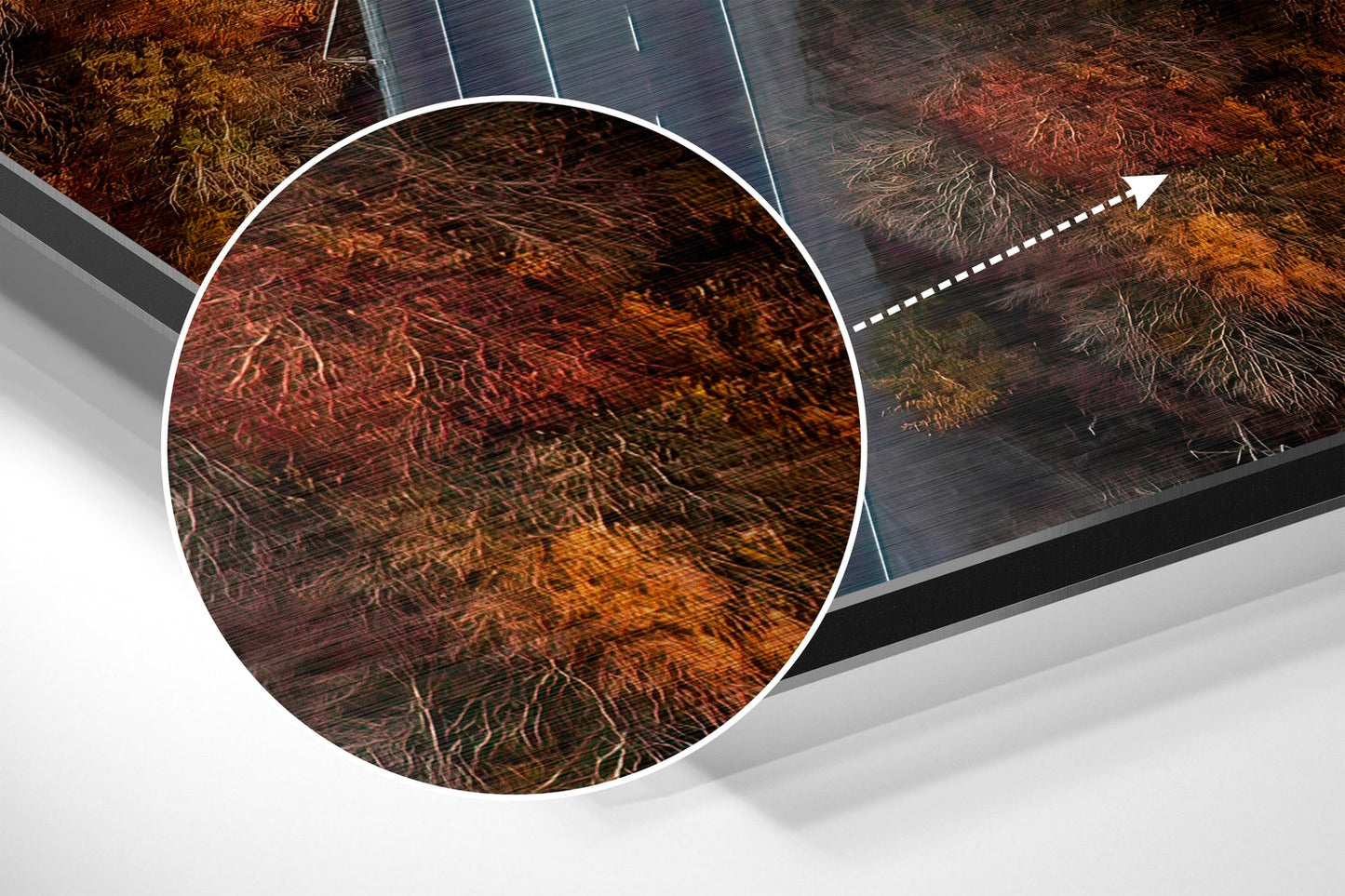 Close-up detail of brushed aluminium Dibond wall art showing textured root patterns in rust, orange, and brown tones with solar panel edge visible.