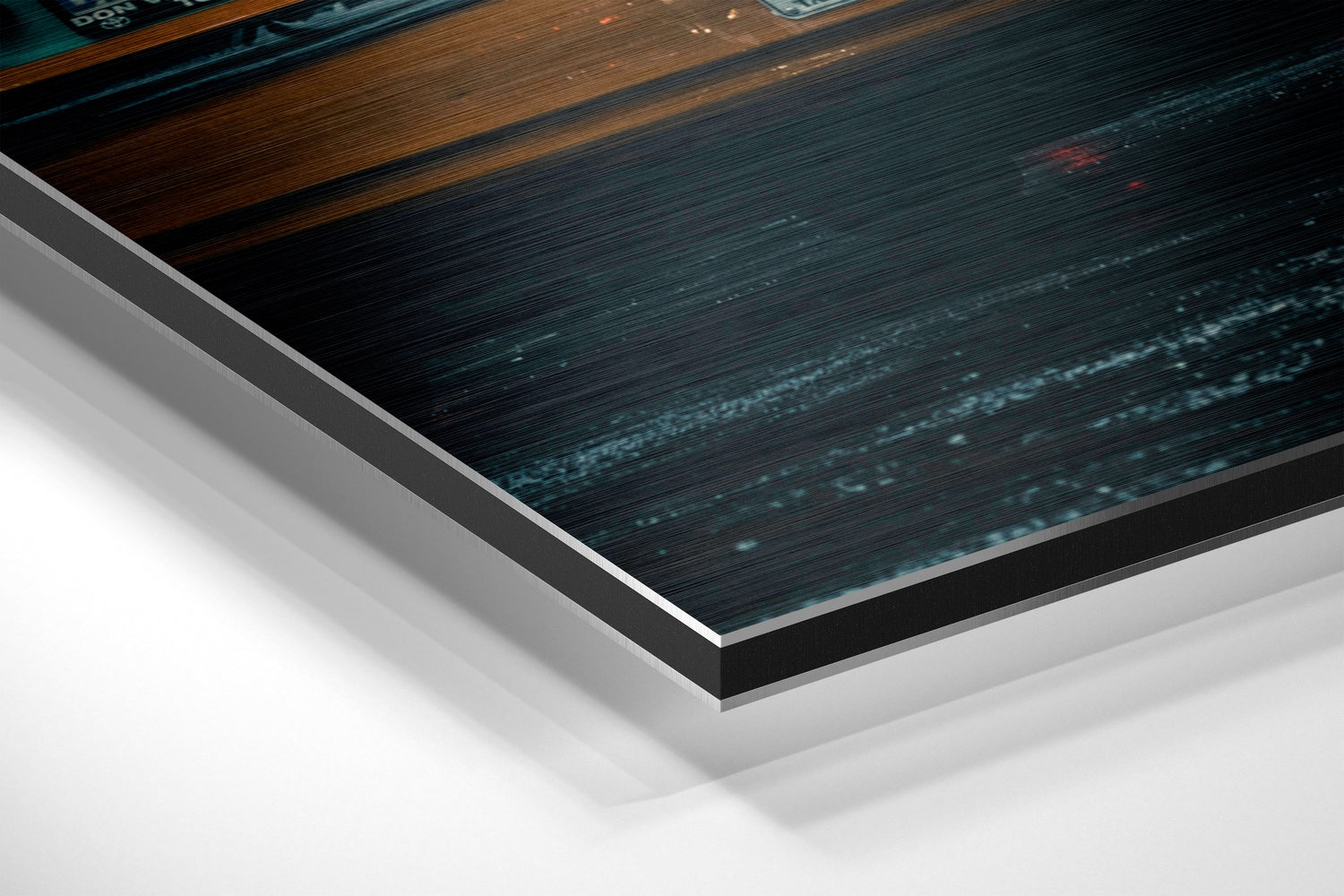 Close-up angled view of City Rush Brushed Aluminium Dibond wall art showing layered edge detail with dark teal and wood textures.