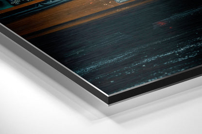 Close-up angled view of City Rush Brushed Aluminium Dibond wall art showing layered edge detail with dark teal and wood textures.
