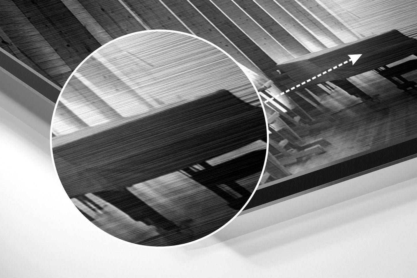 Close-up detail of brushed aluminium surface showing horizontal linear texture and reflective finish in black and white.
