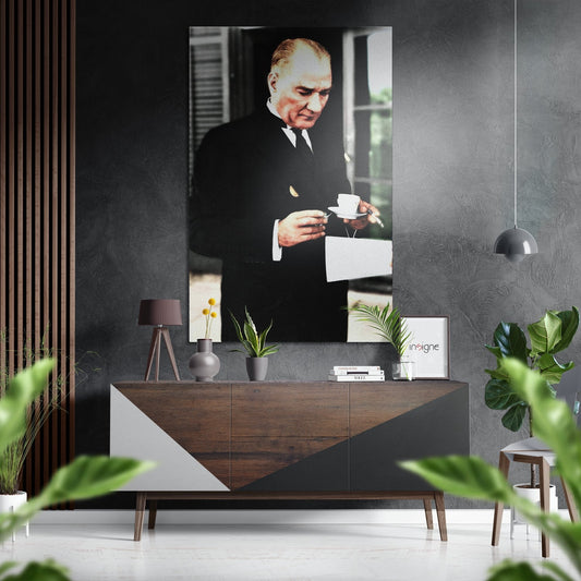 Styled interior scene featuring colorized portrait of man in dark suit holding tea cup mounted on textured gray wall above wooden sideboard.