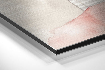 Close-up angled view of brushed aluminum Dibond panel showing layered edge with pink and white brushed metal surface detail.