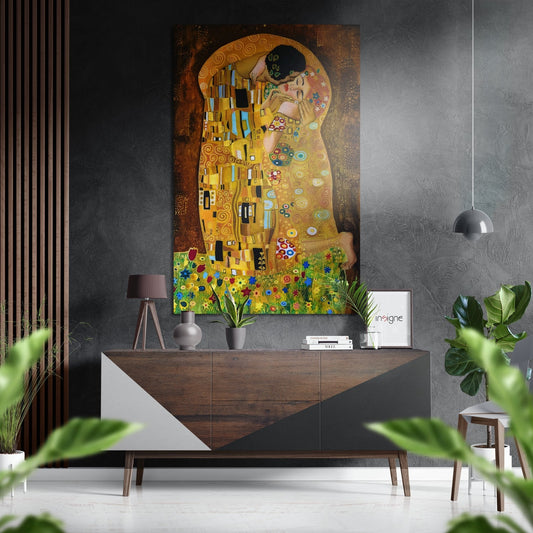 Modern interior featuring Klimt's Kiss artwork mounted above a wooden dresser with pendant lamp and potted plants.