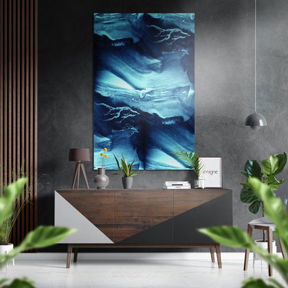 Modern interior room featuring abstract blue and white brushed aluminum wall art displayed above a wooden console table with decor.