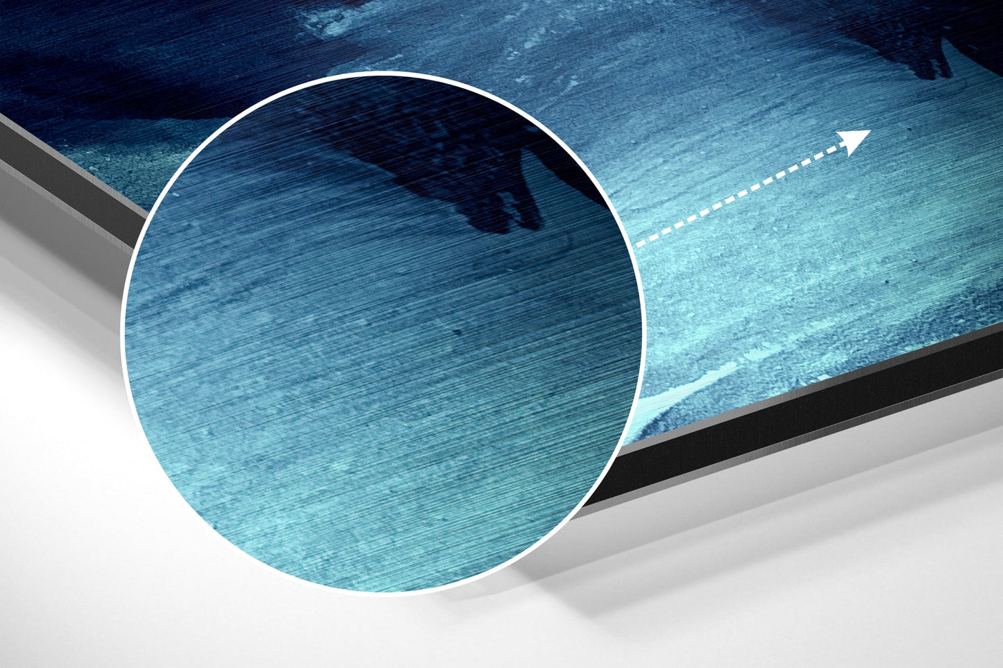Close-up circular magnified view of brushed blue aluminum surface with horizontal texture lines and directional arrow overlay.
