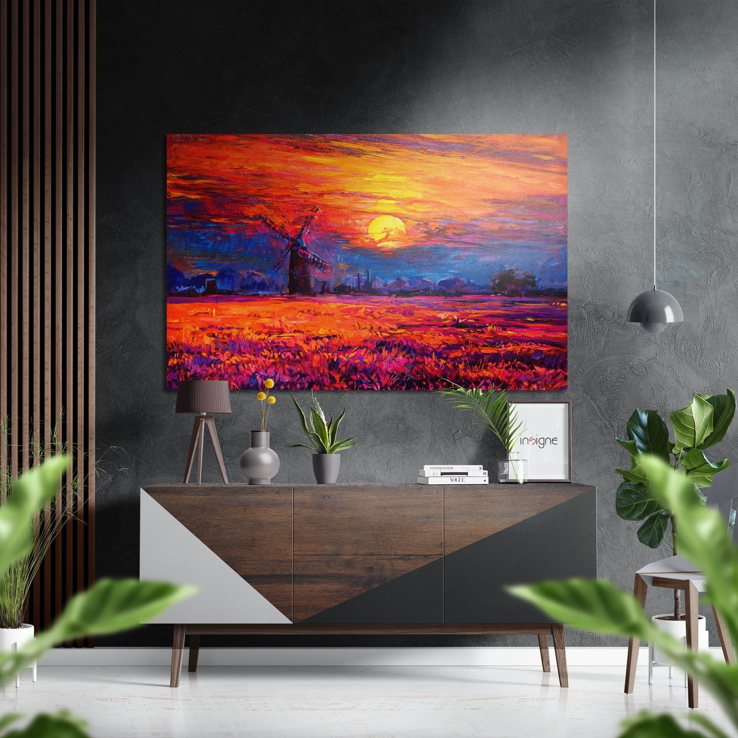 Vibrant sunset windmill artwork displayed above wooden dresser in modern living room with plants and pendant light.