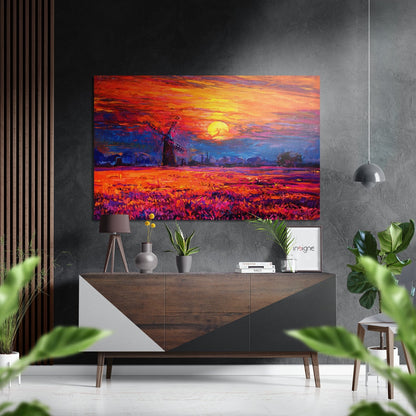 Vibrant sunset windmill artwork displayed above wooden dresser in modern living room with plants and pendant light.