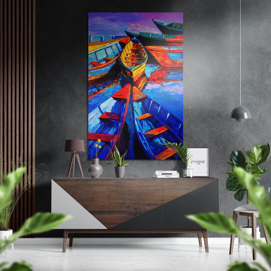 Colorful boats artwork displayed above a wooden console table in a modern interior with gray walls and potted plants.
