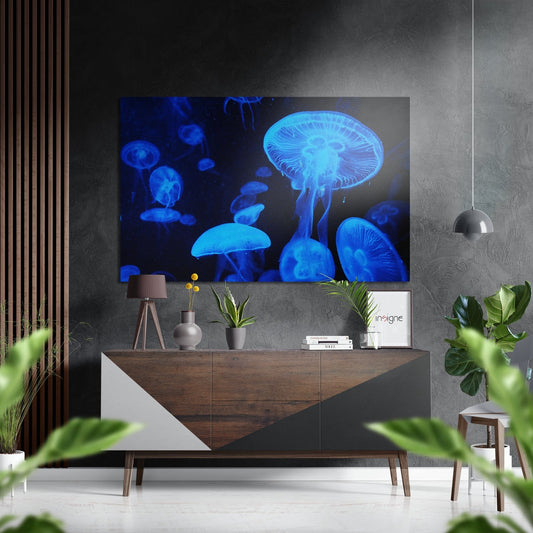 Glowing blue jellyfish artwork displayed above a wooden console table in a modern living room setting with plants and decor.