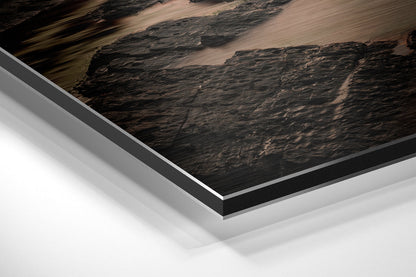 Close-up angled view of layered Dibond panel showing dark textured landscape print with white and gray aluminum backing layers.