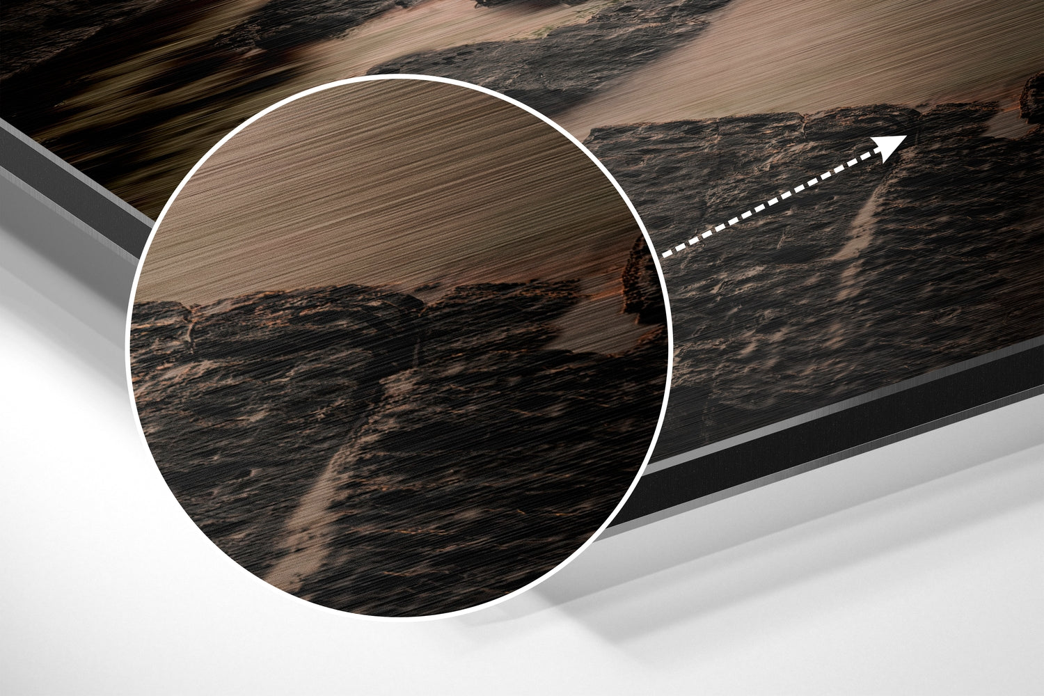 Close-up detail of brushed aluminum surface texture with circular magnified view of dark wood grain pattern and arrow pointer.