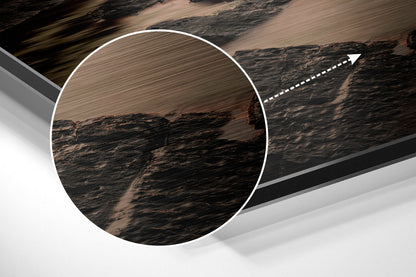 Close-up detail of brushed aluminum surface texture with circular magnified view of dark wood grain pattern and arrow pointer.