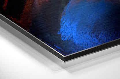 Close-up angled view of brushed aluminum dibond print edge showing blue and red tones with layered mounting construction.