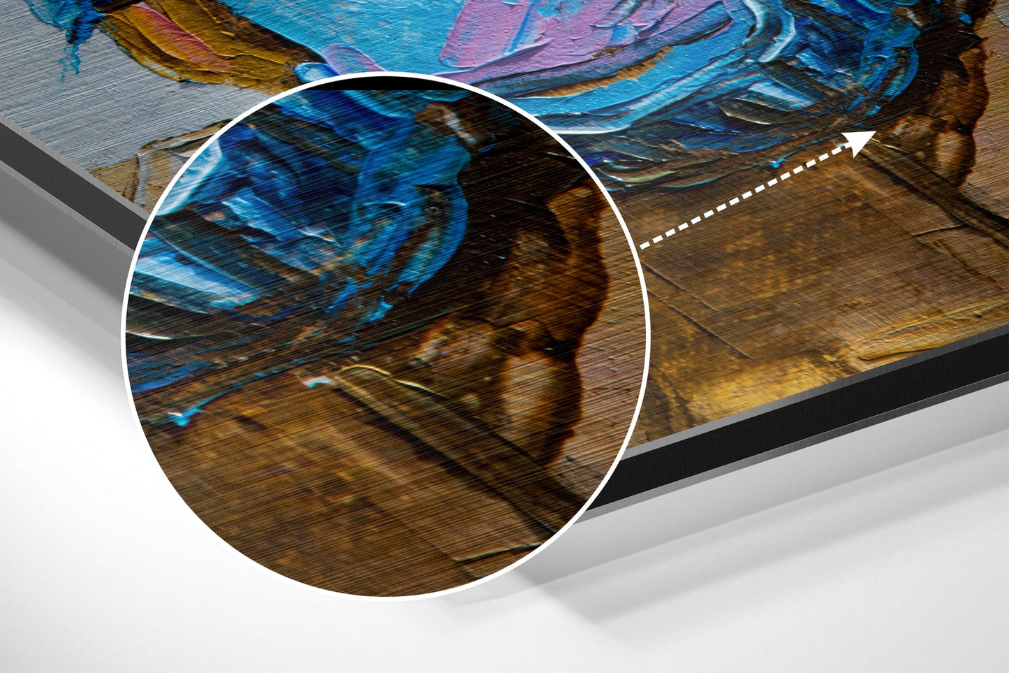 Close-up detail of brushed aluminium surface showing blue and brown painted brushstrokes with magnified circular inset highlighting texture.