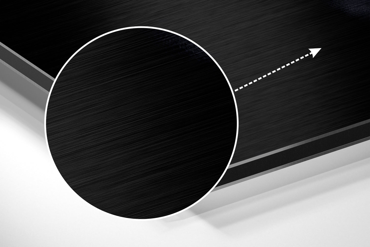 Abstract geometric composition featuring a large white-outlined black circle on brushed metal surface with directional arrow.