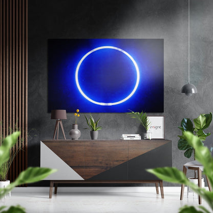 Neon blue glowing circle ring on dark background, displayed above wooden media console in modern living room setting.