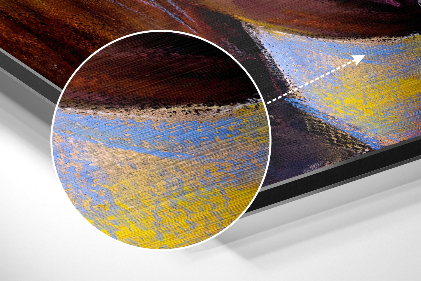 Close-up detail of brushed aluminium wall art showing textured blue, yellow, and rust-colored horizontal striations with magnified circular inset.