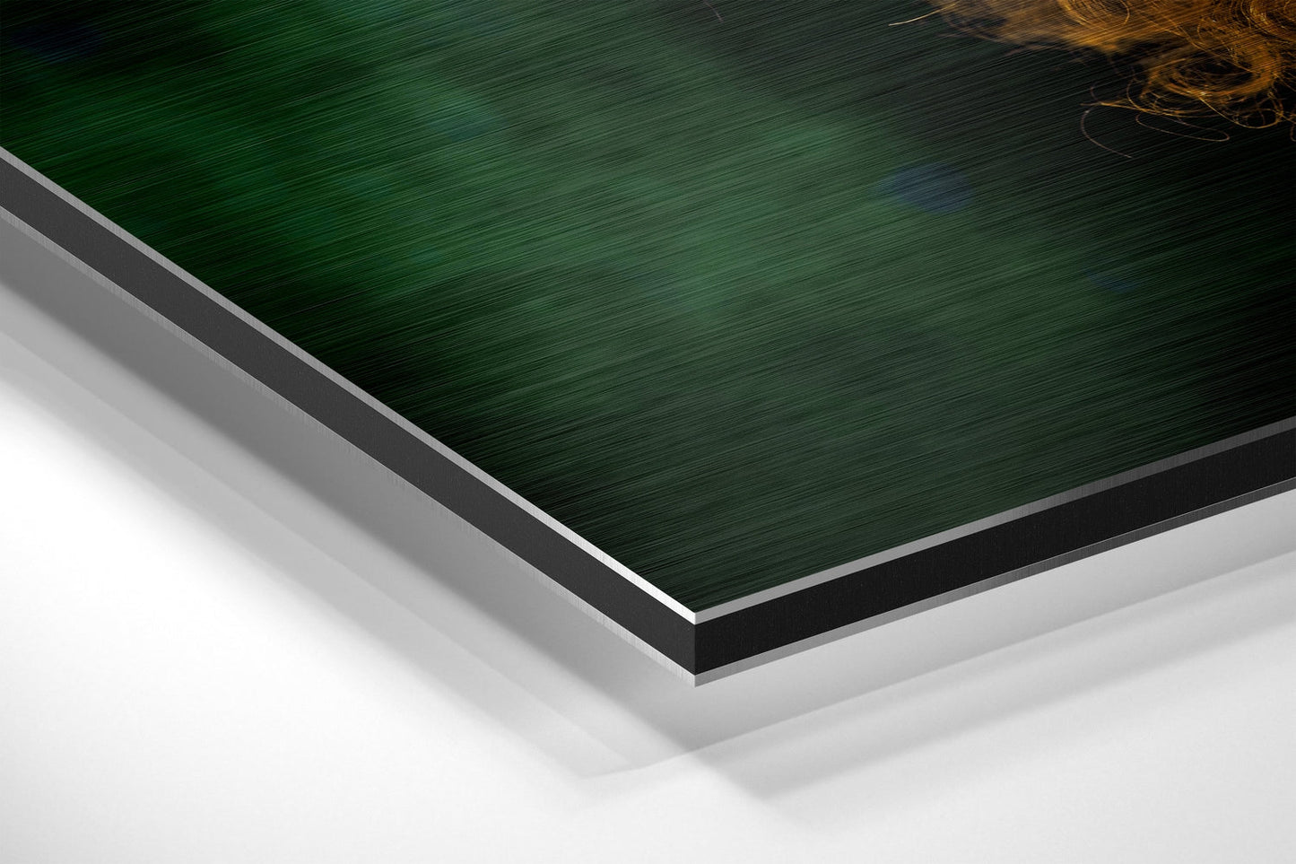 Close-up angled view of layered Dibond panel edges showing green brushed aluminum surface with black and white backing layers.