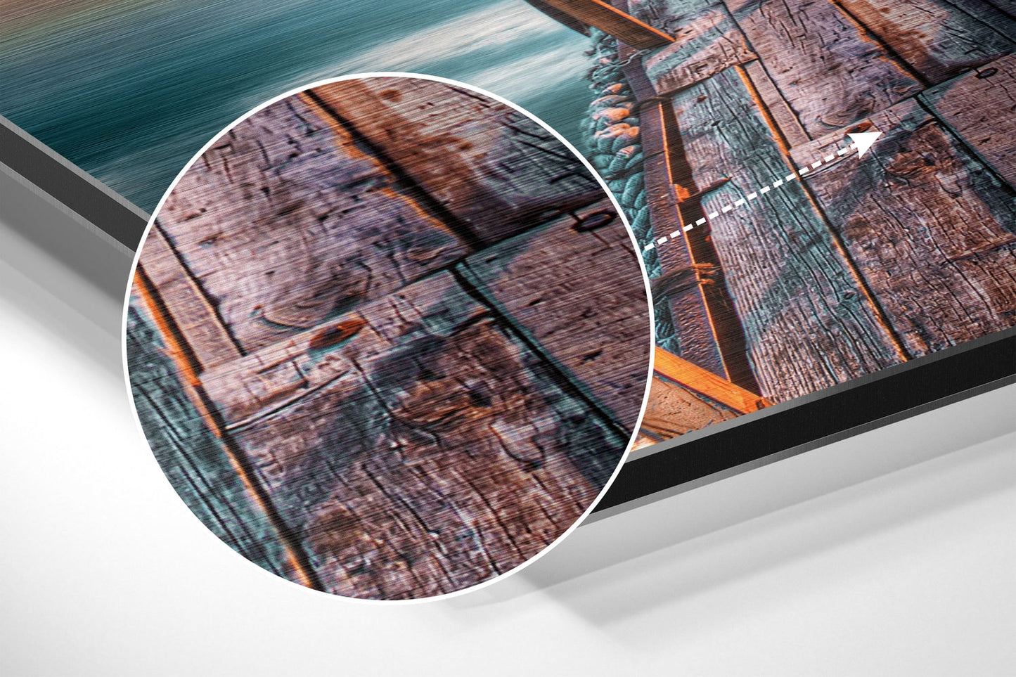 Close-up detail of weathered wooden dock planks with rope and turquoise water, showing brushed aluminum surface texture and warm orange tones.