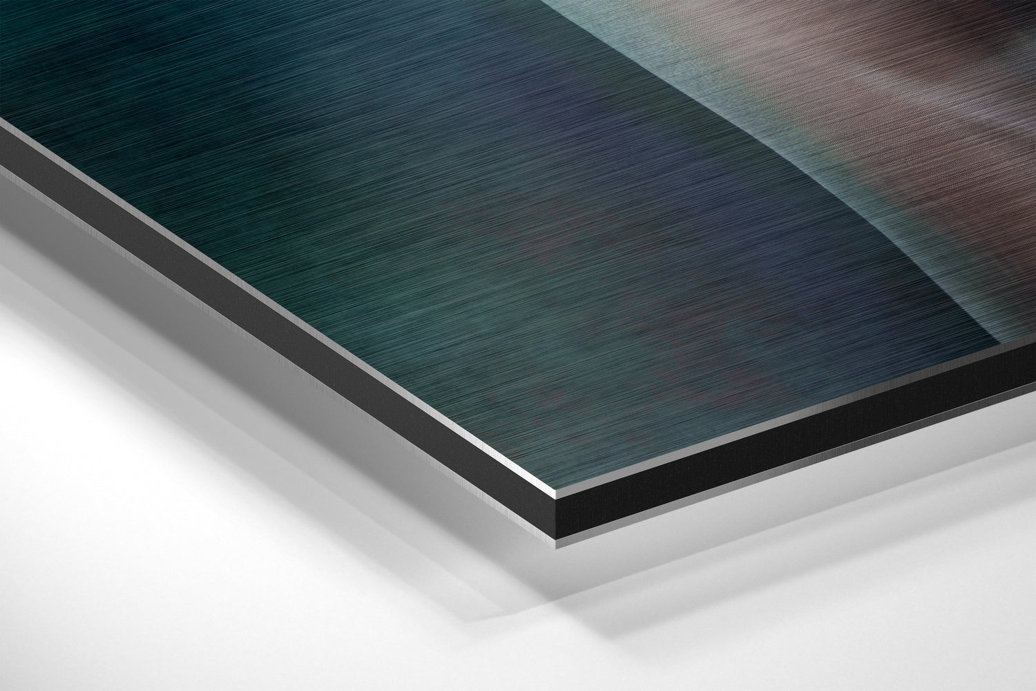 Angled overhead view of stacked Dibond sheets showing teal, gray, and white brushed aluminum layers with visible edge details.