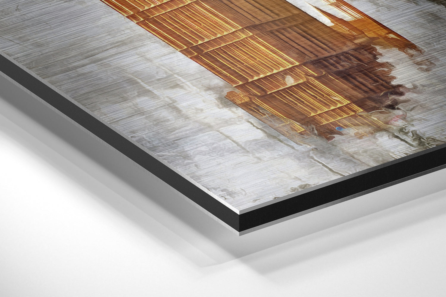Close-up angled view of brushed aluminium Dibond wall art showing layered mounting with black border and white backing.