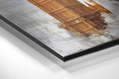 Close-up angled view of brushed aluminium Dibond wall art showing layered mounting with black border and white backing.