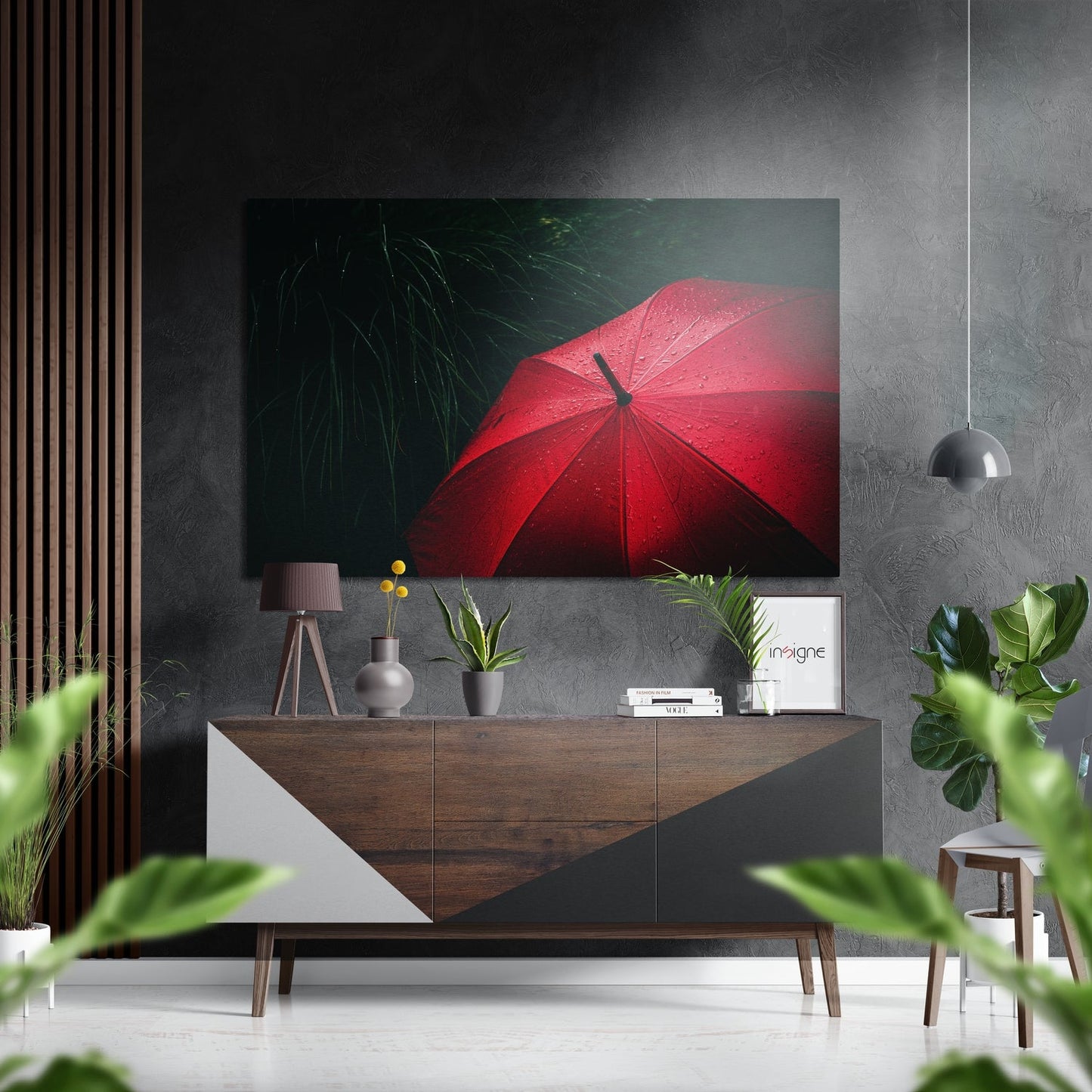 Red umbrella with raindrops on dark green background, displayed above wooden console in modern interior setting.