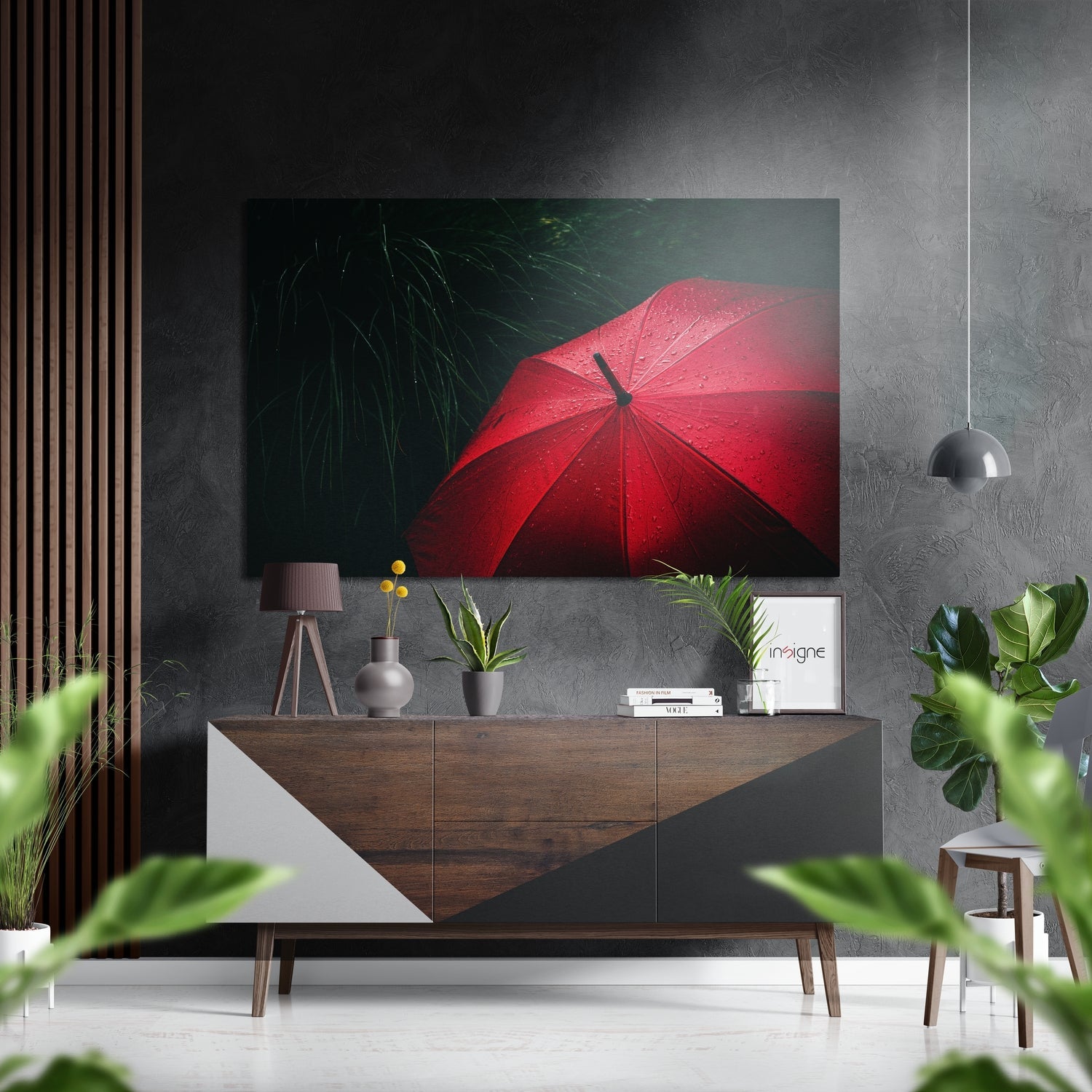 Red umbrella with raindrops on dark green background, displayed above wooden console in modern interior setting.