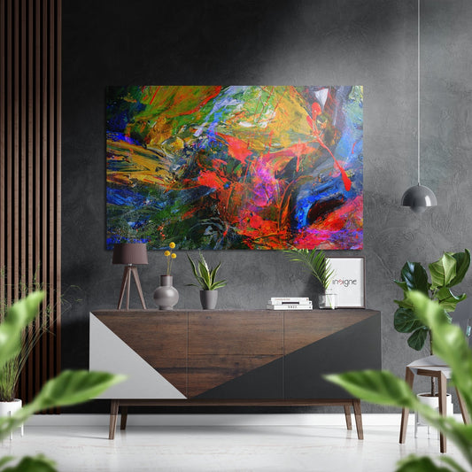 Vibrant multicolored abstract painting with red, blue, green, and yellow impasto brushstrokes displayed above wooden console table in modern interior setting.