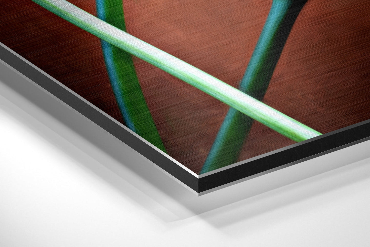Close-up angled view of brushed aluminum dibond panel edge showing layered construction with black border and white backing material.