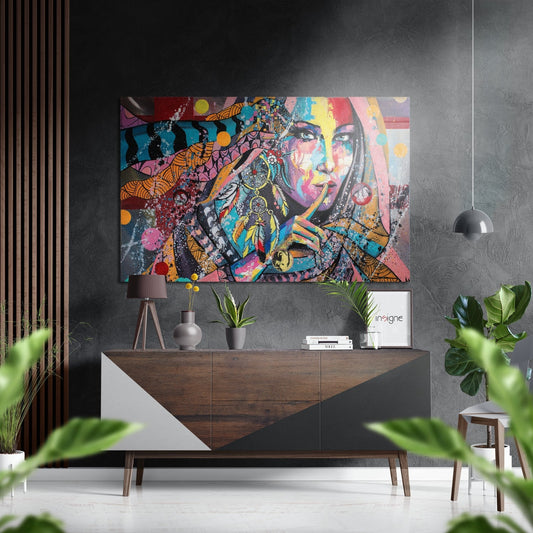 Colorful pop art portrait with vibrant geometric patterns displayed above a wooden console table in a modern interior setting.