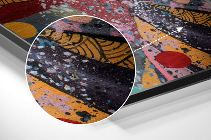 Close-up detail of brushed aluminium wall art showing textured surface with abstract patterns in black, yellow, pink, red, and blue paint splatters.
