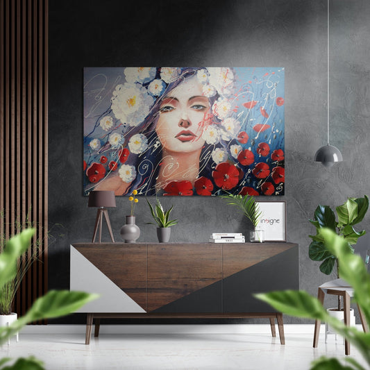 Modern interior room featuring a portrait metal wall art of a woman surrounded by white daisies and red poppies, displayed above a wooden dresser with plants and decor.