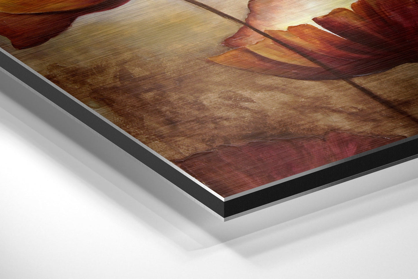 Close-up angled view of layered aluminum dibond print showing warm brown and red tones with translucent edge detail.
